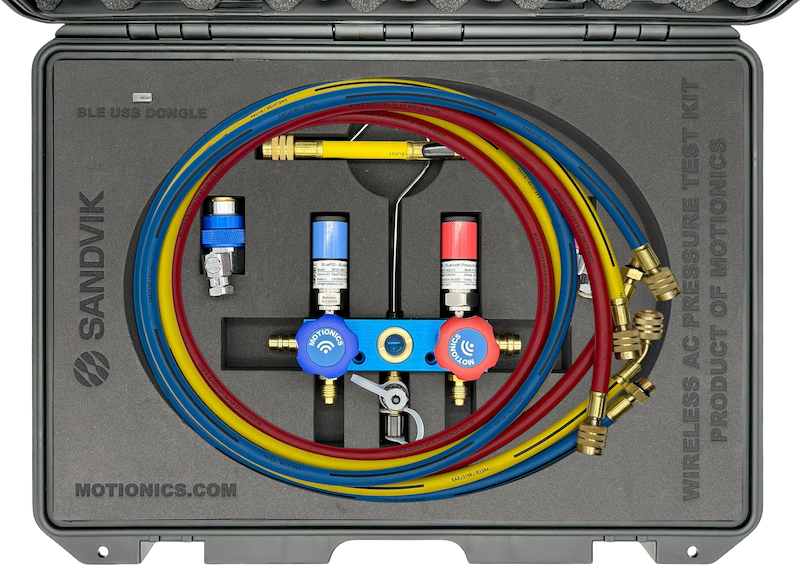 Interior view of Sandvik SHOT AC Kit by Motionics with wireless valves, pressure sensors, and color-coded hoses
