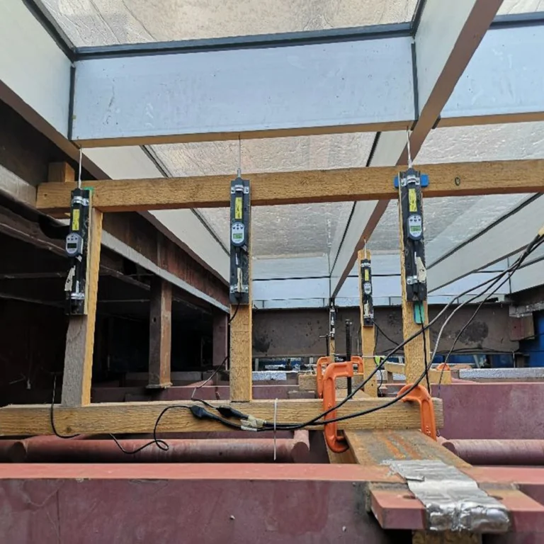 BlueDial: Bluetooth Digital Dial Indicator – An ISO17025 testing facility based in Bahrain has developed methods for conducting tests that accommodate international standards for glazed curtain walling systems.

With the help of Motionics’ wireless dimensional measurement tools, they were able to record deflection measurements for clients while maintaining the wind pressure conditions specific to each project.

A direct requirement of the testing standards for these systems is to provide the client with accurate deflection levels of the mullions supporting the glazing units under design wind loads.

The chambers are designed to be airtight, with suction/pressure fans/blowers providing the pressure to simulate the effect of advised wind pressures for the project at hand.

In order to accurately record the deflection or movement of the glazing system, the operators needed to acquire inducers/deflection gauges and a monitoring system that could record
deflection readings at given points of the system over the course of the test, all while maintaining the strict test conditions as required by each of the relevant testing standards. Read the full case study on our website to learn more. #BlueDial #PileSense #InTheField [Ref: 1026250418]